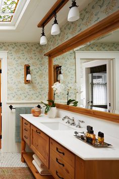 a bathroom with two sinks and a skylight in it's center window above the sink