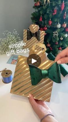 someone is making a christmas ornament out of gold and green paper with a bow tie on it