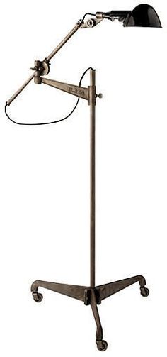 a desk lamp sitting on top of a metal stand