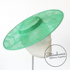 This emerald cartwheel hat base is a classic shape that has sprung into popularity in the past year. Made from 2 layers of stiffened sinamay, these cartwheels are ready to trim and are fitted with a petersham ribbon on the inside crown edge. Simply add a comb or headband to secure to the head.Hat base measures:Width: 35.5cm (14 inches)Crown Width: 13.5cm (5.3 inches)Crown Height: Approximately 3.5cm (1.7 inches)For even more millinery supplies you can find us here:www.etsy.com/shop/PetershamsAll Adjustable Green Hat Bands For Kentucky Derby, Adjustable Green Hat Band For Kentucky Derby, Green Adjustable Hat Bands For Kentucky Derby, Fitted Green Hat Bands For Kentucky Derby, Fitted Green Hat Band For Kentucky Derby, Green Fitted Hat Band For Kentucky Derby, Green Brimmed Straw Hat For Garden Party, Green Flat Brim Hat For Kentucky Derby, Adjustable Green Brimmed Boater Hat