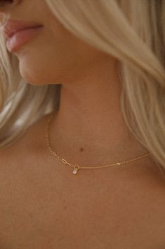 Achieve an elegant look with this dainty gold necklace. Featuring a delicate yet durable gold chain and subtle charm, this necklace stands out without being overbearing. Perfect for adding a finishing touch to your look. 18k gold dipped waterproof hypoallergenic rhinestone charm dainty chain Everyday Delicate 14k Gold Charm Necklaces, Delicate 14k Gold Charm Necklace For Everyday, Delicate 14k Gold Charm Necklaces For Everyday, Minimalist 14k Gold Charm Necklace, Minimalist 14k Gold Charm Necklace With Gold Chain, Everyday Tarnish-resistant Recycled Gold Charm Necklace, Elegant Recycled Gold Charm Necklace, Dainty 14k Gold Filled Charm Necklaces For Everyday, Dainty Everyday Charm Necklaces In 14k Gold Filled