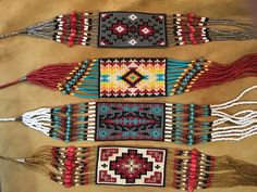 four native beaded bracelets are displayed on a table