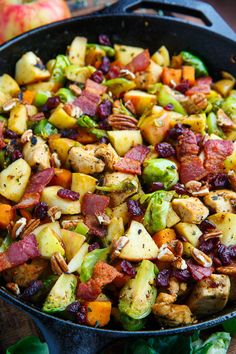 a skillet filled with potatoes, brussel sprouts and bacon