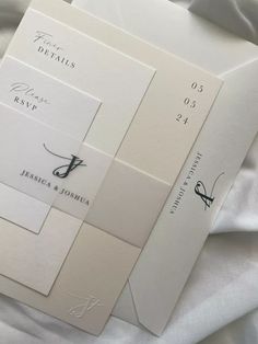 the wedding stationery is laid out on top of each other