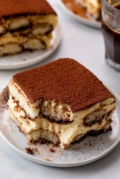 there are two desserts on the plate and one is cut in half to show it's filling