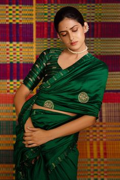 Emerald green haritah embroidered saree with mandala motifs. Comes with blouse.
Component: 2
Pattern: Embroidery
Type Of Work: Mandala
Sleeve Type: Half
Fabric: Maheshwari Silk
Color: Emerald Green
Other Details: 
Zari embroidery
Tassel detailing
Occasion: Wedding - Aza Fashions