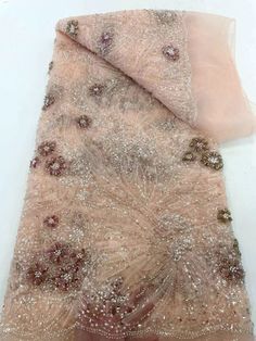 an image of a piece of cloth with sequins and beads on the fabric