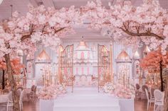 an elegant wedding setup with pink flowers and trees