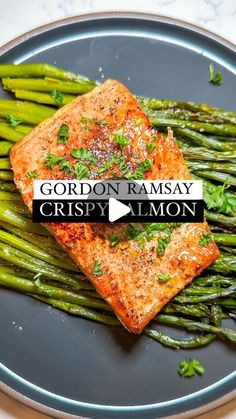 salmon and asparagus on a plate with the caption gordon ramsay crispy salmon