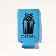 a blue can cooler with a raccoon in it that says trashhed on the side