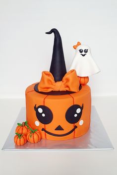 there is a cake decorated to look like a jack - o'- lantern and ghost