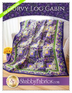 a purple and green quilt with flowers on it