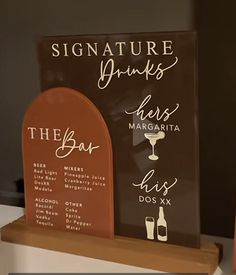 there are two signs that say the bar and the wine list on each sign,