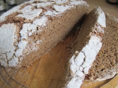 a loaf of bread sitting on top of a wooden cutting board