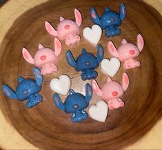 there are many small figurines in the shape of rabbits on a wooden plate