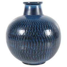 a blue vase is shown on a white background