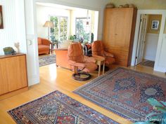 a living room filled with furniture and rugs