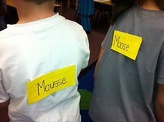 two children with yellow sticky notes on their backs, one boy is wearing a mouse shirt