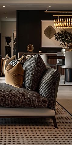 a living room filled with lots of furniture and pillows on top of a rug covered floor