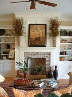 a living room filled with furniture and a fire place under a painting on the wall