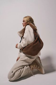 Sling style faux sherpa fabrication adjustable sherpa-padded shoulder strap mini strap pocket hidden side zipper pocket zipper closure Street Style Bags, Free People Bags, Free People Activewear, Brown Crossbody Bag, Sweatsuit Set, Backpacking Packing, Free People Movement, Fp Movement, Walker Boots