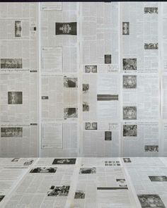 a bunch of newspapers are spread out on the table top, with papers scattered around them