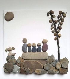 a group of rocks sitting on top of a pile of stones next to a tree