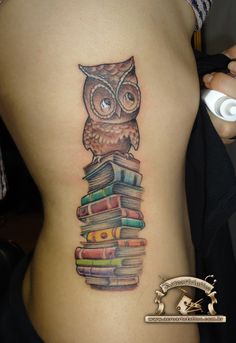 an owl sitting on top of a stack of books