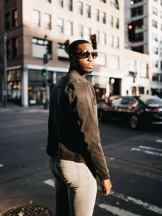 a man standing on the sidewalk in front of a traffic light