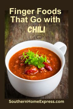 a white bowl filled with chili and garnished with cilantro