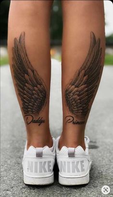 a woman's legs with tattoos and wings on her leg, both showing the word nike