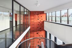 an indoor area with glass walls and metal handrails, leading to the second floor