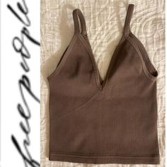 Top Trending Free People Movement Happiness Runs V Neck Tank Top Size: Medium Color: Chocolate Not Available On Fp Site Also Have Burgundy Wine Color Shown In Pic Brand New Without Tags Retails: $48.00 Also Have In Another Color No External Logo Purchased From Reputable Fp Wholesaler Get Your Sweat On In This Lightweight Ribbed Active Tank From Our Best-Selling Happiness Runs Collection Featured In A Cropped Design That Stretches With You As You Move. V-Neckline Light Compression Flattering Seam Taupe V-neck Summer Tops, Stretch V-neck Brown Tank Top, Beige Seamless V-neck Crop Top, Trendy Brown V-neck Top, Brown V-neck Crop Top, Chic Seamless Brown Crop Top, Trendy Brown V-neck Tank Top, Chic Brown Seamless Crop Top, Chic Brown Seamless Tops