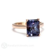 a tan gold ring with a blue sapphire stone