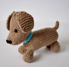 a small knitted dog with a blue collar