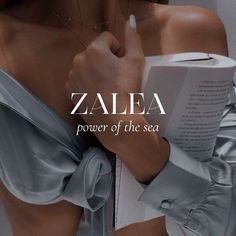 a woman is reading a book with the word zaleaa in front of her