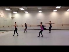 four dancers in a dance studio practicing their moves