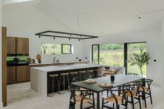 an open kitchen and dining room area with large sliding glass doors leading to the backyard