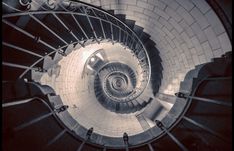 a spiral staircase is shown in black and white, with the light at the end