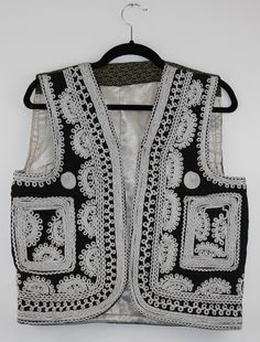 A rare find vintage sleeveless waistcoat from Afghanistan. Size: S/M Bust: 16.5 Inches Height: 20 Inches Note: Worn and minor signs of wear. Fitted Sleeveless Vest For Festival, Fitted Vintage Vest With Embroidery, Vintage Embroidered Fitted Vest, Traditional Summer Vest, Traditional Sleeveless Summer Vest, Vintage Fitted Embroidered Vest, Traditional Black Sleeveless Vest, Traditional Sleeveless Vest For Spring, Traditional Sleeveless Spring Vest