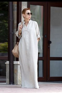 "The fabric from which the model is currently made is a combination of Linen and cotton What to wear in the summer? Stylish and elegant long linen shirt-dress. Two pockets. Front opening. Decorative buttons.  Side openings. White linen fabrics are always transparent Material: 65% Linen / 35% Cotton HEIGHT OF MODEL: 168 cm. / 5′ 6″  Size S We accept Returns and Exchange All garments are handmade. Please provide your PHONE NUMBER for delivery   EXPRESS delivery for ALL ORDERS   Accessories are not Long Linen Shirt Dress, Long Linen Shirt Outfit, Long Sleeve Linen Dress, Linen Dress Elegant Classy, Linen Shirt Dress Outfit, Abaya Plus Size, Shirtdress Outfit, Linen Dresses Elegant, Dress Elegant Classy