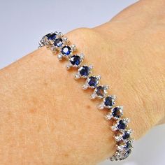 An astonishing original completely hand crafted 18K white gold 1930s line bracelet set with gorgeous blue sapphires and fine white diamonds. This sinuous and sexy original Art Deco jewel is amazingly sparkly and elegant. Each of the links moves beautifully and it drapes beautifully across the wrist due to the exceptional workmanship and delicate links. What is astonishing is the immaculate and skilled work to make each and every link by hand which is very seldom seen. You really can feel the dif Solid Gold Bangle, Sapphire Anniversary, Blue Sapphire Bracelet, Trending Bracelets, Bracelet Diamond, Mens Silver Necklace, Bracelets Gold Diamond, Art Nouveau Jewelry, Blue Sapphire Diamond