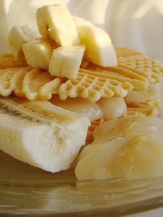 a banana and waffle sandwich on a glass plate