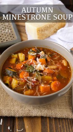 a bowl of minestone soup with bread on the side