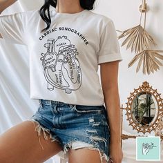 🌟 Bulk discounts available! See details in description below. 🌟 Inspired from vintage anatomical diagrams, this shirt makes for the perfect cardiac sonographer gift! Soft and lightweight, with the right amount of stretch. It has a classic unisex relaxed fit that is comfortable and flattering for everyone! DETAILS: * Made to order * Unisex sizing (details in photos) * Solid colors are 100% combed and ring-spun cotton * Heather colors are 52% combed and ring-spun cotton, 48% polyester * Pre-shru Cardiac Sonography Shirts, Cardiac Sonography, Anatomy Shirts, Heart Anatomy, Medical Anatomy, Country Girls, Shirt Price, Mix Match, Anatomy