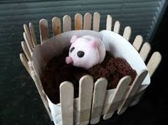 a small toy pig is sitting in the middle of a pile of dirt and sticks