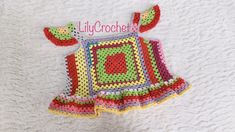 a crocheted baby dress with the name lily crochet on it's chest