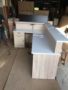 a man is working on an unfinished desk