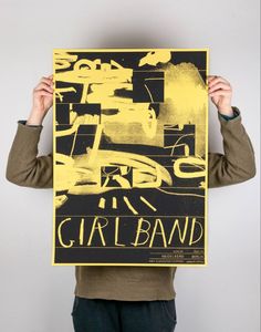 a person holding up a poster with the words girl band on it