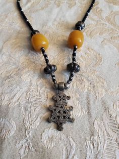 Vintage Ethiopian, Star of David, Cross 18 inch Necklace, Black , Silver Toned and Yellow Bead, Costume Jewelry, Fashion Accessory This is a nice find and very collectible.  Very durable and strong. The pendant measures 1.50 inches tall and .75 inches wide. Check out our shop for monthly specials. We have a variety of items for every taste. Combine several of our items together to save on shipping. If you have any questions please do not hesitate to ask. I will ship outside of the US, just request a quote. Happy Shopping. I will work around the priority mail price. Just send me your zip code and I will get a quote. As shop owners we will do our best to describe any issues or problems with our items. Since we do sell vintage and antiques there may be some flaws. Please check out the picture Handmade Black Star Necklace, Black Bohemian Cross Necklace, Bohemian Black Cross Necklace, Black Pendant Jewelry With Large Beads, Black Star-shaped Spiritual Jewelry, Black Spiritual Star-shaped Jewelry, Black Star Of David Necklace, Spiritual Style, Black Star Of David Spiritual Necklace, Black Spiritual Necklace With Star Of David